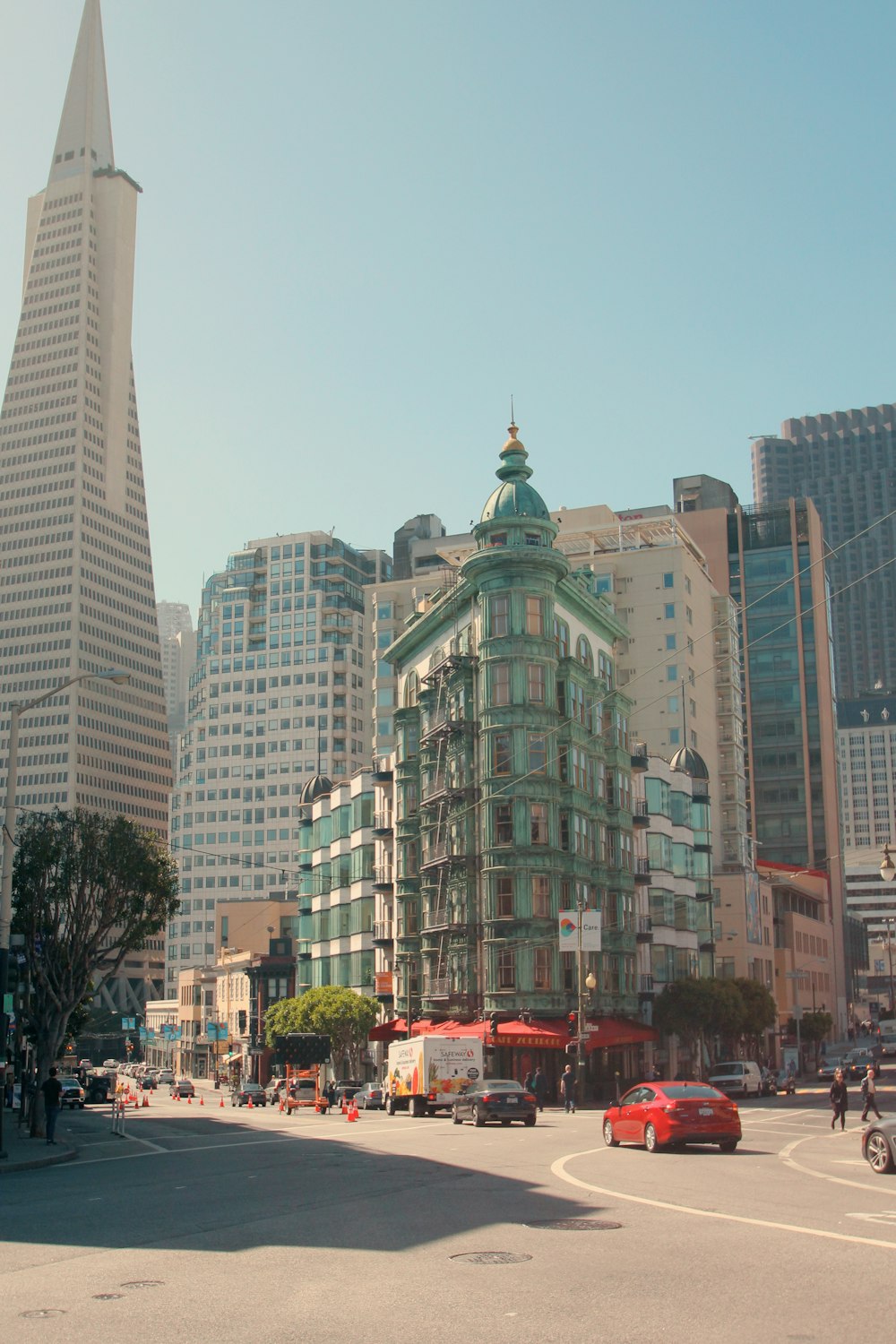 cars on road near high rise buildings during daytime