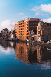 brown and beige concrete building near body of water during daytime