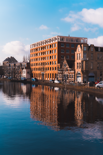 brown and beige concrete building near body of water during daytime