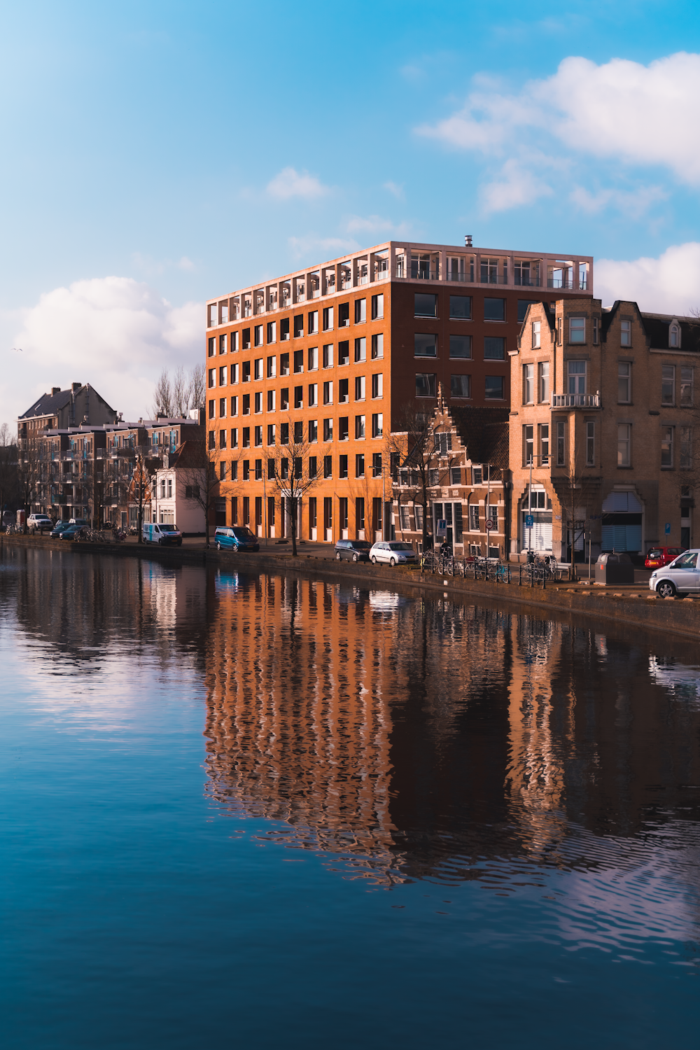 brown and beige concrete building near body of water during daytime