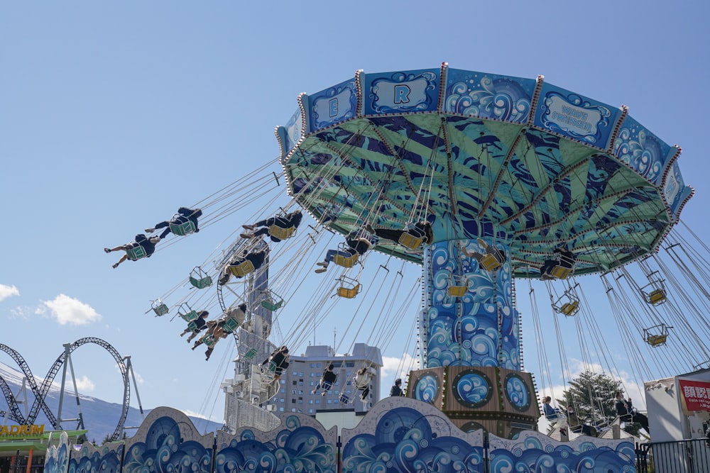 blue and green ferris wheel under blue sky during daytime