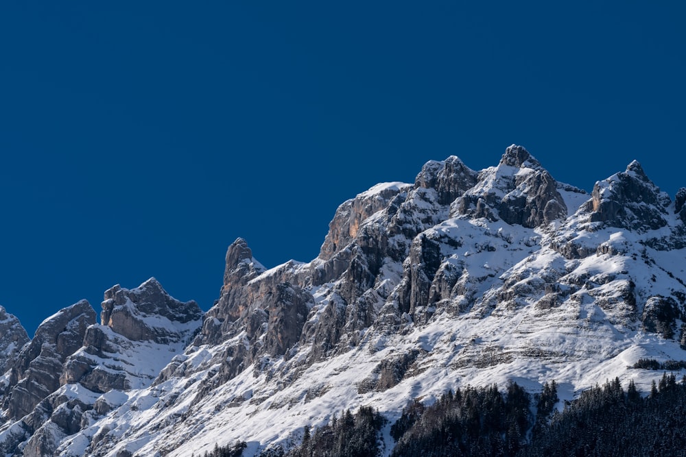 snow covered mountain under blue sky during daytime