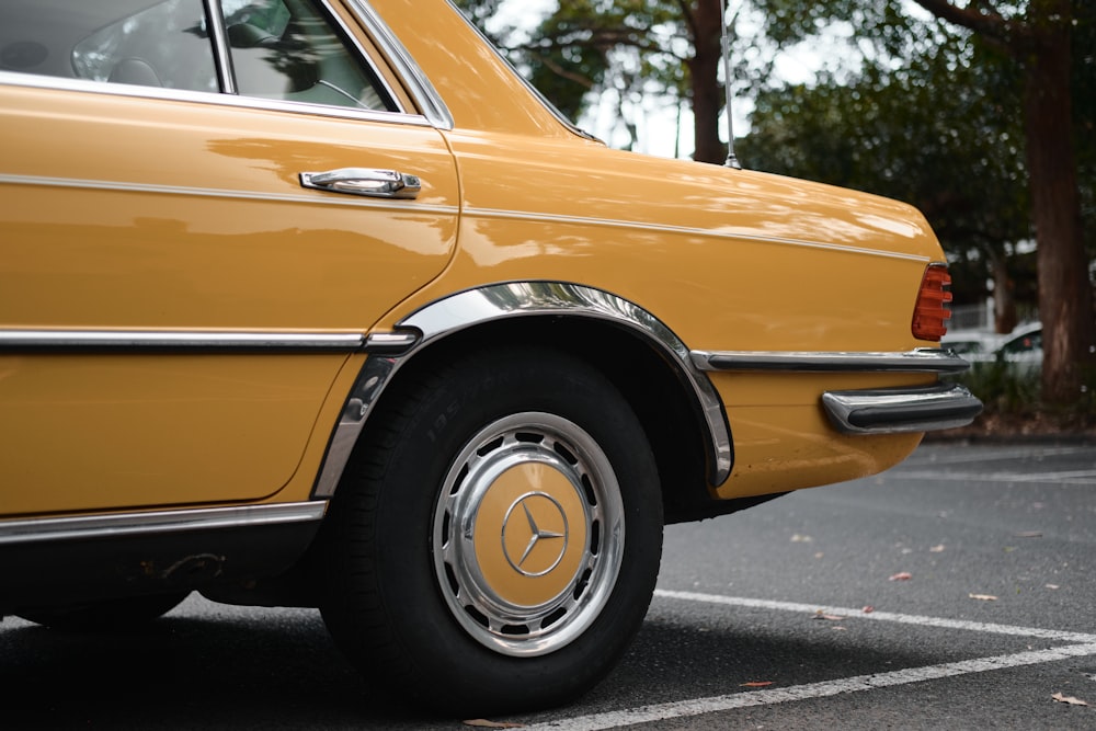 yellow car on gray asphalt road during daytime