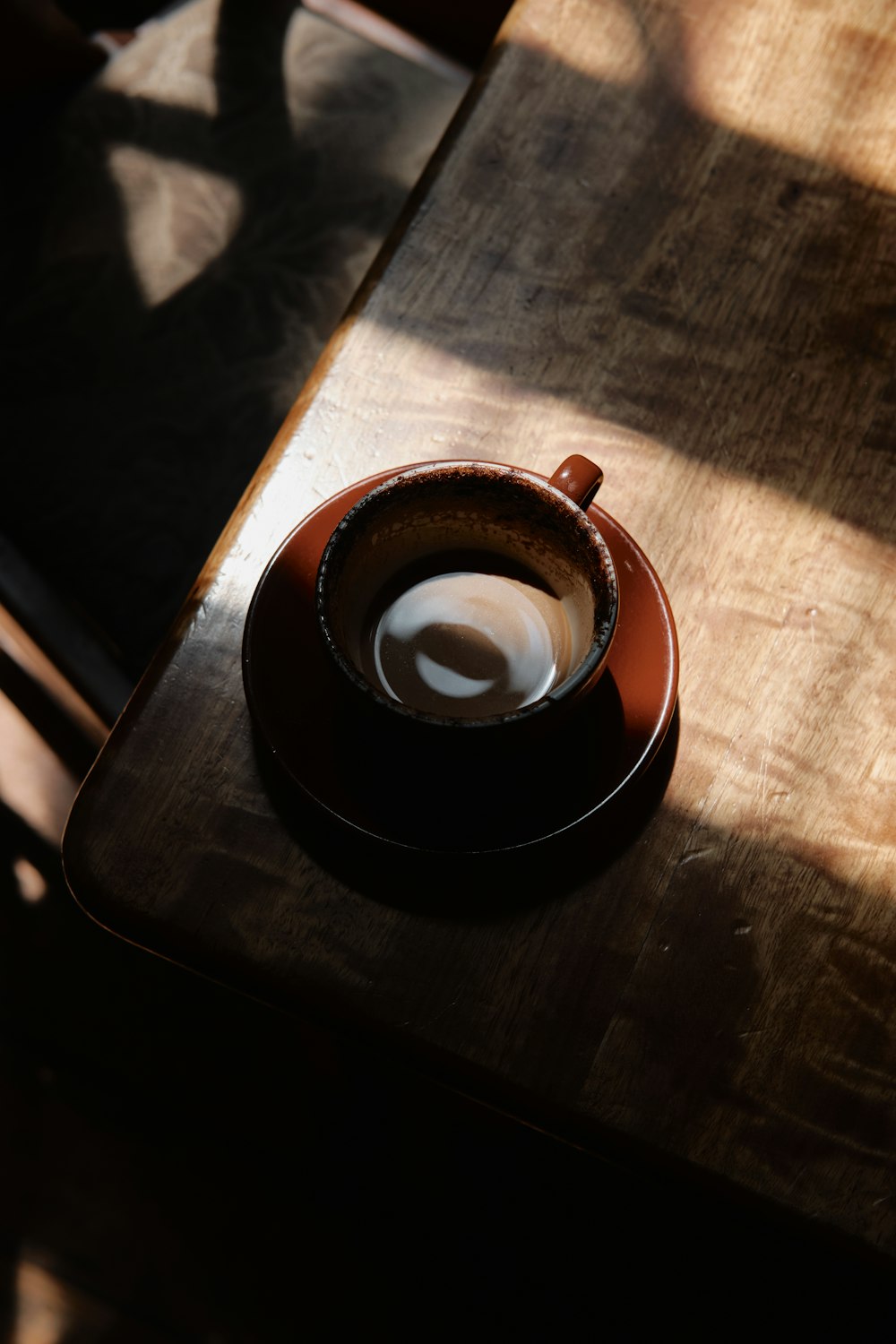 brown ceramic mug on brown wooden table