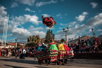 A vibrant group of dancers from different backgrounds performing joyfully outdoors in New York City.