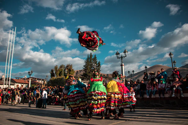 A vibrant Capoeira roda with students performing acrobatic moves in a sunny outdoor setting.