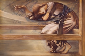 A contemplative figure leans wearily on a wooden loom, draped in a flowing dress with soft, muted colors. Her head rests on her arms, eyes closed, conveying a sense of exhaustion or deep thought. The background features subtle plant motifs, enhancing the serene and introspective atmosphere.
