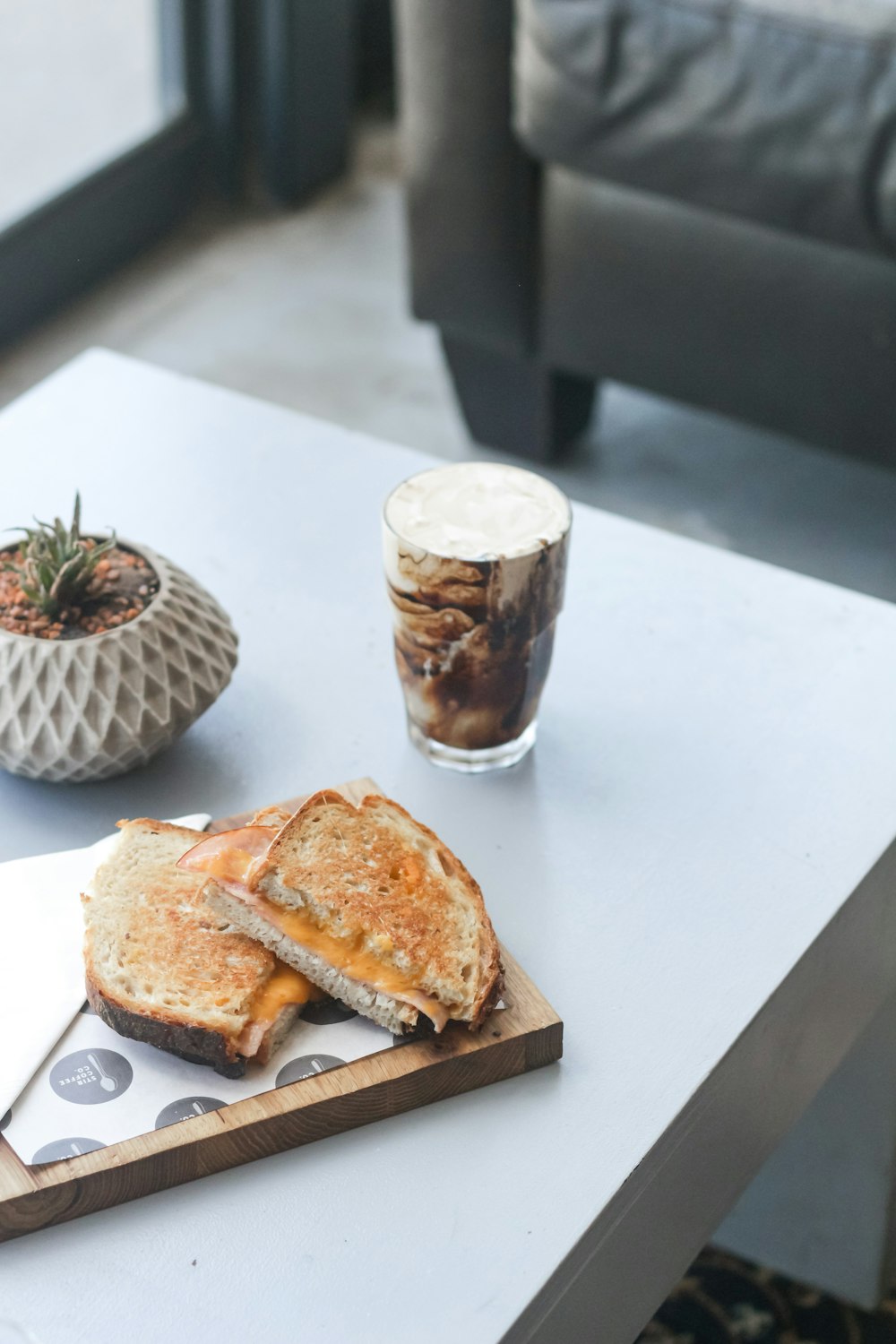 Brot auf weißem Keramikteller neben klarem Trinkglas