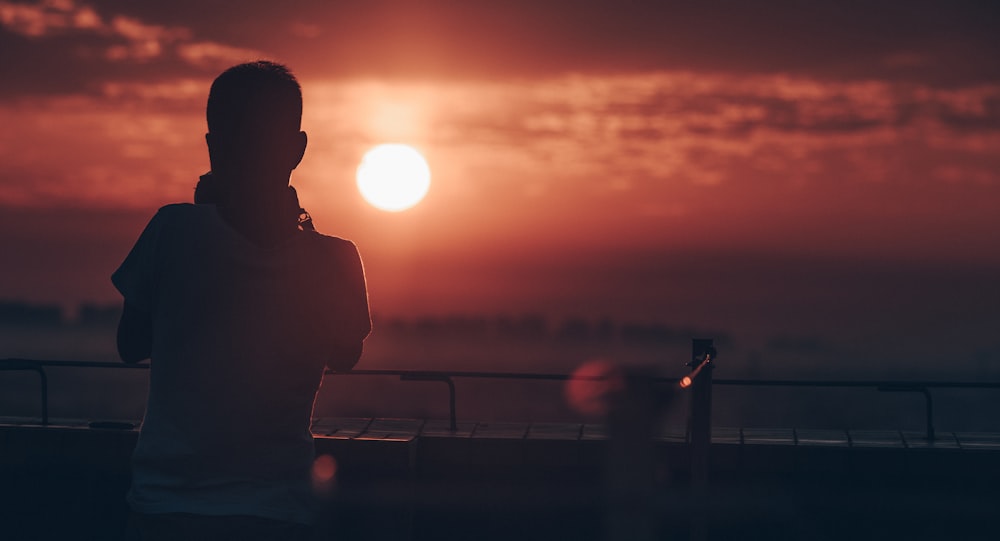 silhouette of man standing during sunset