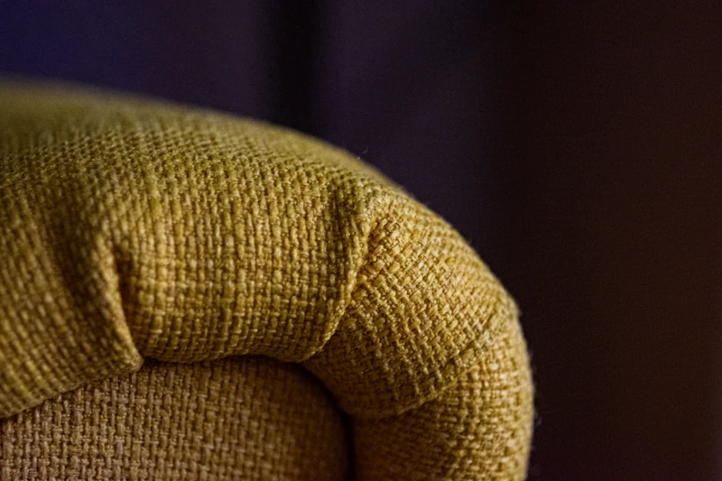 Close-up of sofa arm showing woven fabric texture