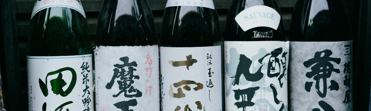 white and black bottles on black wooden shelf