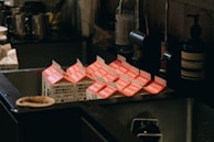 A variety of creamy milk cartons from different countries displayed on a shelf.