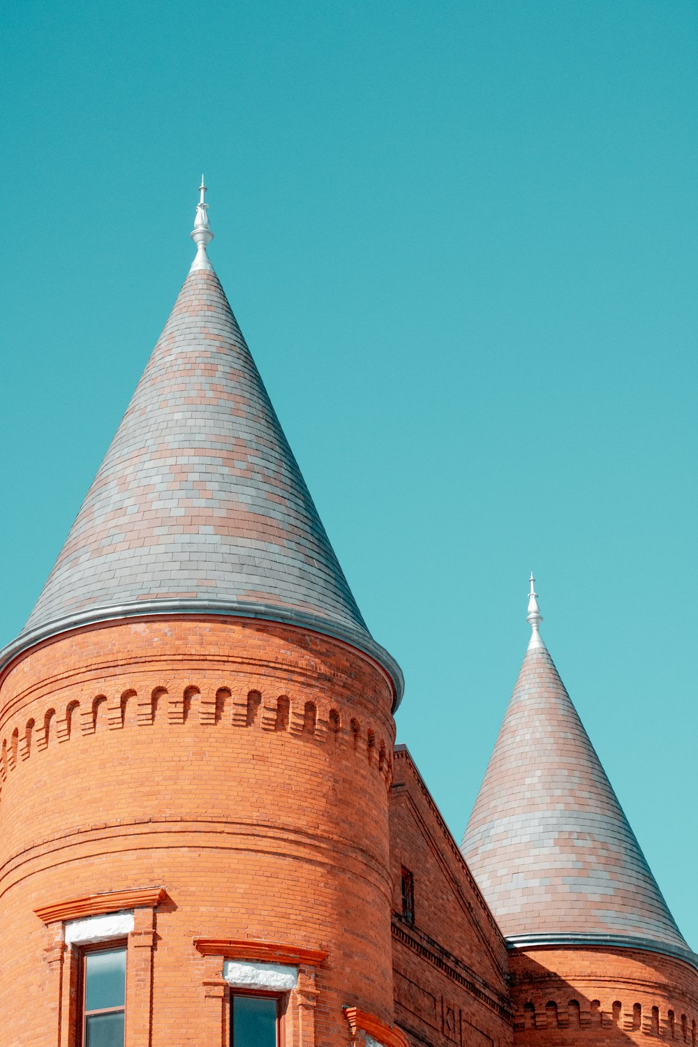 brown and gray concrete tower under blue sky during daytime