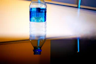 Brightly colored water bottle showcasing a swirling abstract pattern with initials 'L.M.' embedded in the design.