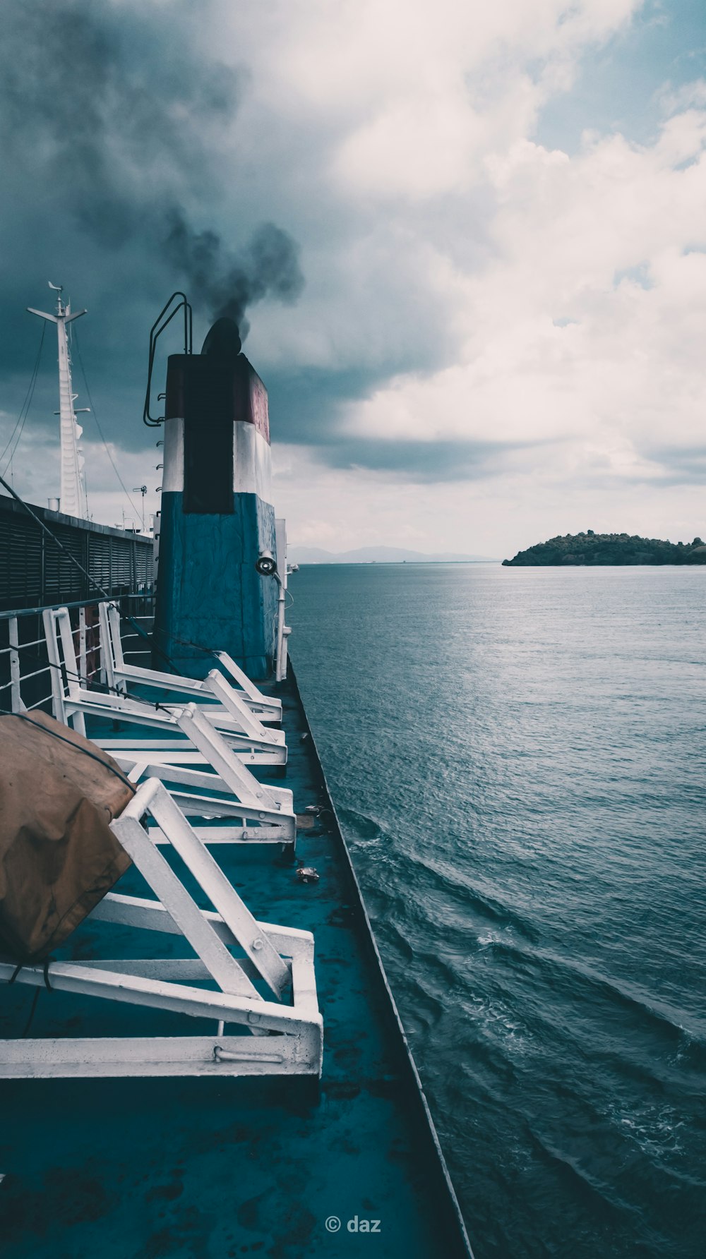 white wooden dock on sea under cloudy sky during daytime