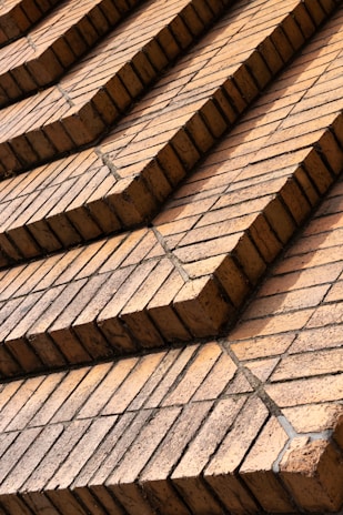 Steel grey and brick red heavy-duty bricks arranged methodically outside the manufacturing unit at Chandi Ceramic.