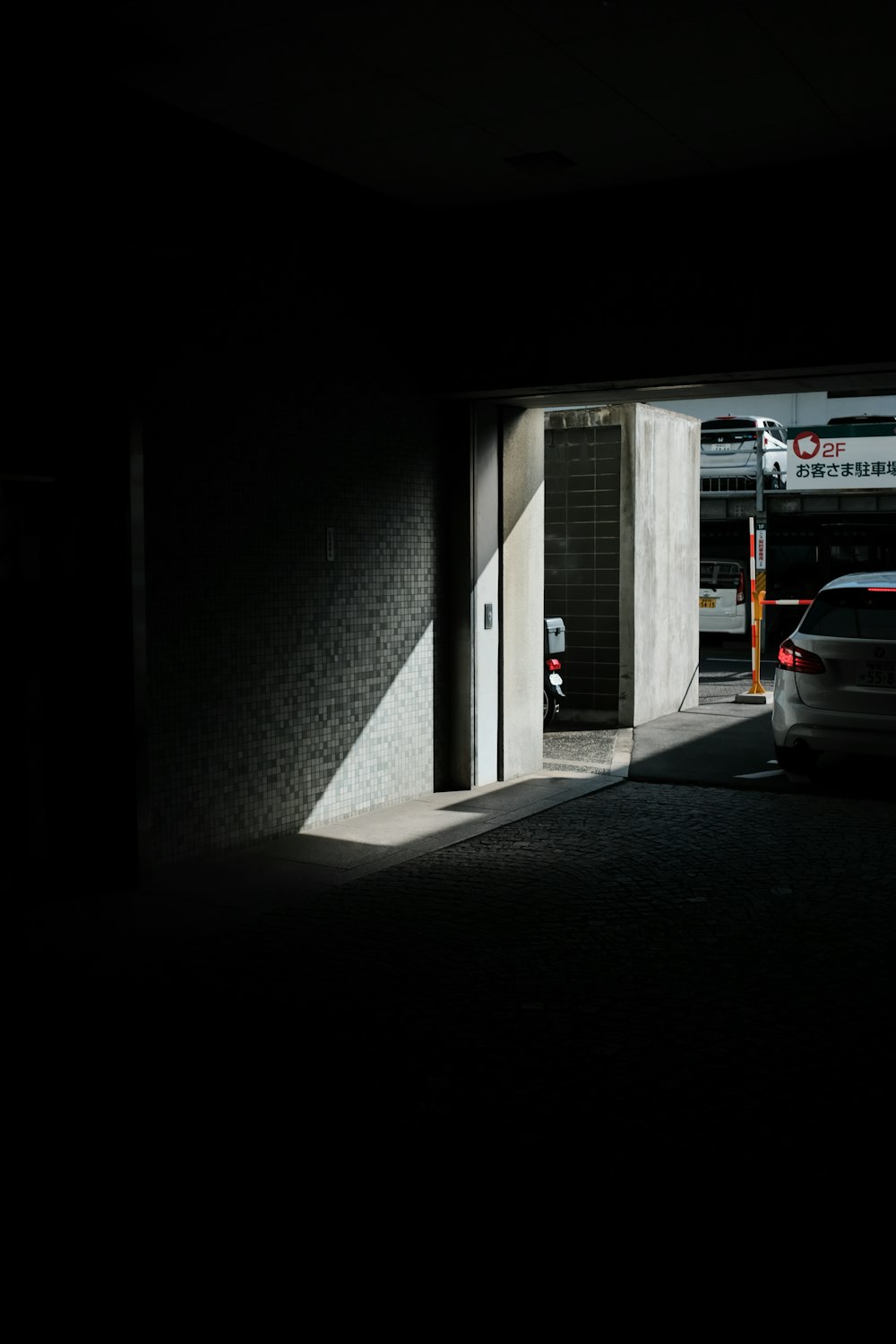 white car parked beside white building