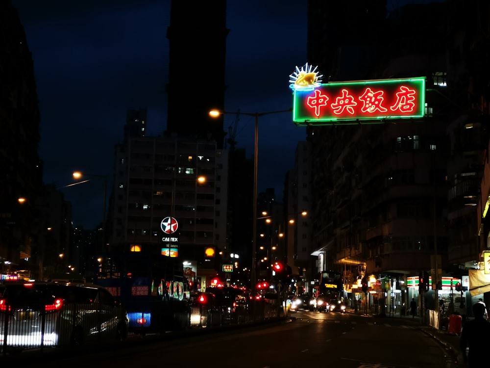 city buildings with kanji text signage during night time
