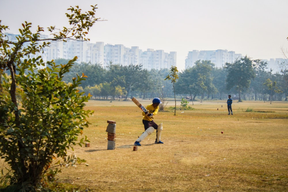 man in yellow shirt and black pants playing golf during daytime