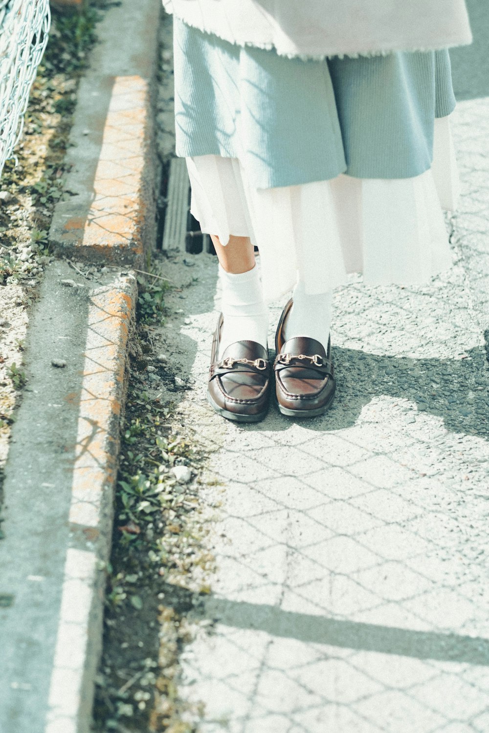 woman in white skirt and black leather sandals