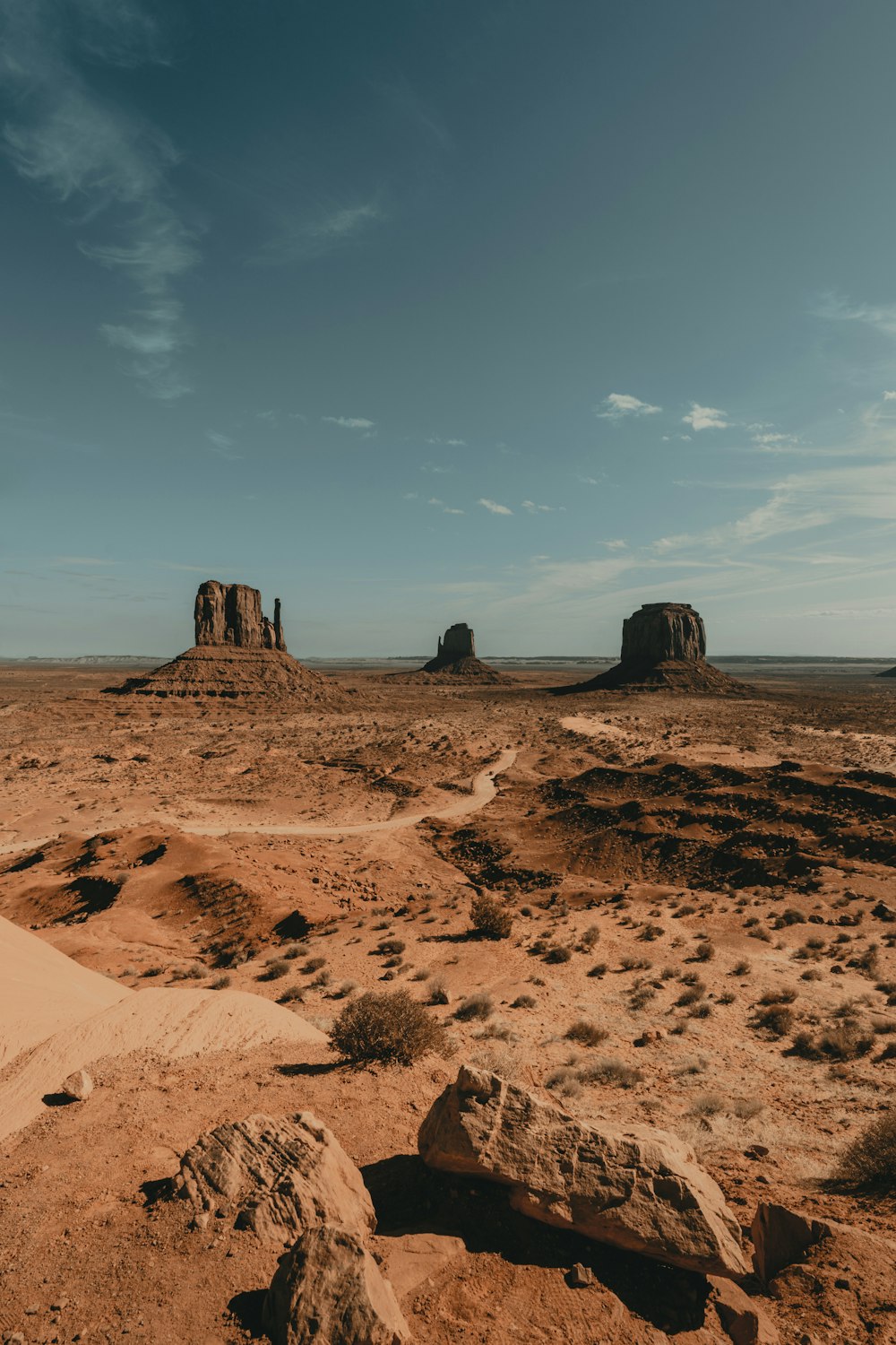 brown rock formation under white clouds during daytime