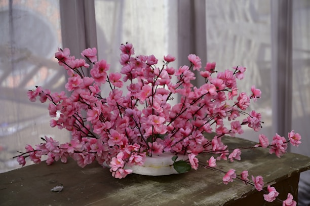 A beautifully framed stock image featuring a serene workspace with soft sakura pink accents.
