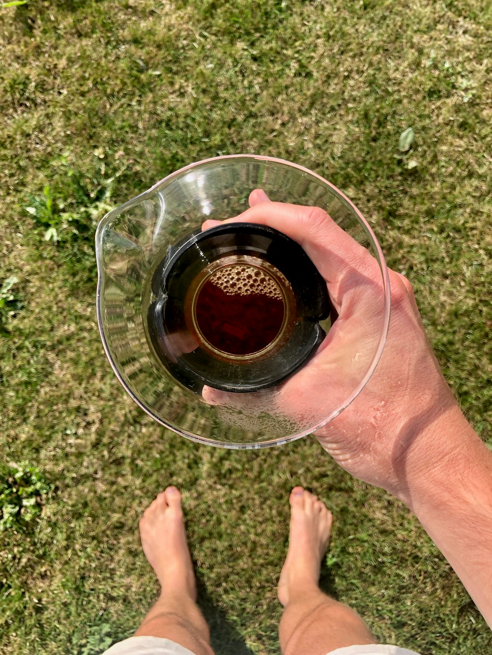 clear drinking glass with brown liquid