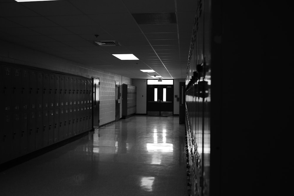 grayscale photo of hallway with glass doors