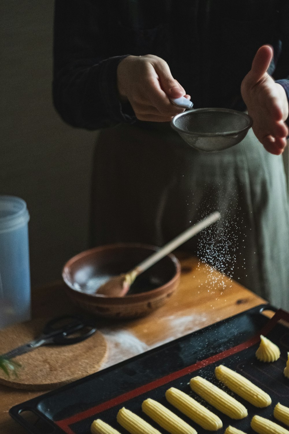 person holding silver spoon and brown wooden bowl