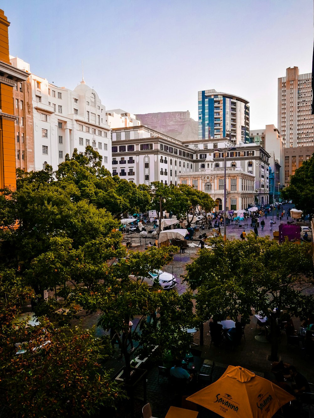 cars parked on side of road near buildings during daytime