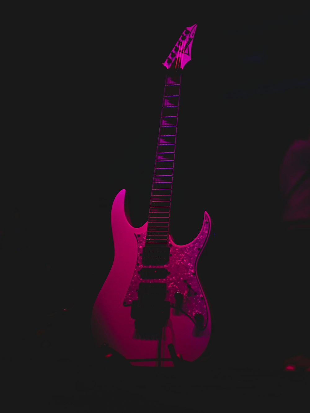 pink and black electric guitar