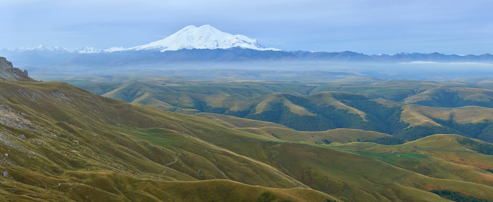 green and brown mountains under white clouds during daytime