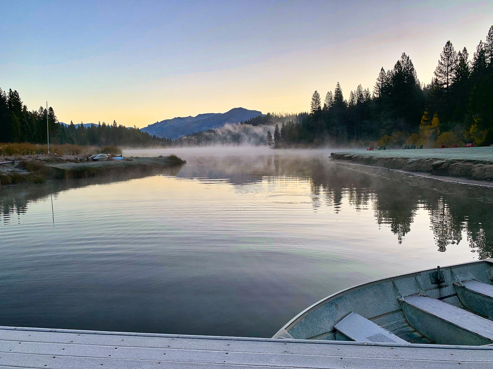 A still, misty lake at dawn