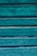 Weathered wooden panels painted in a vibrant teal color, displaying a rustic and textured surface with visible grain patterns and variations in the paint.