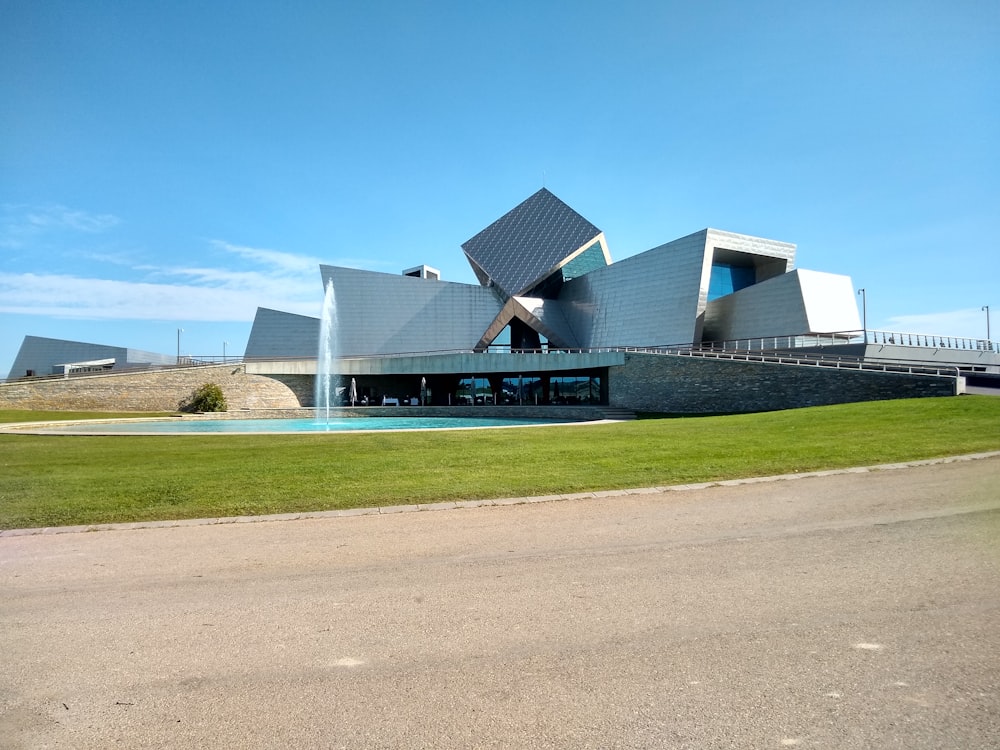 white and blue building near green grass field during daytime