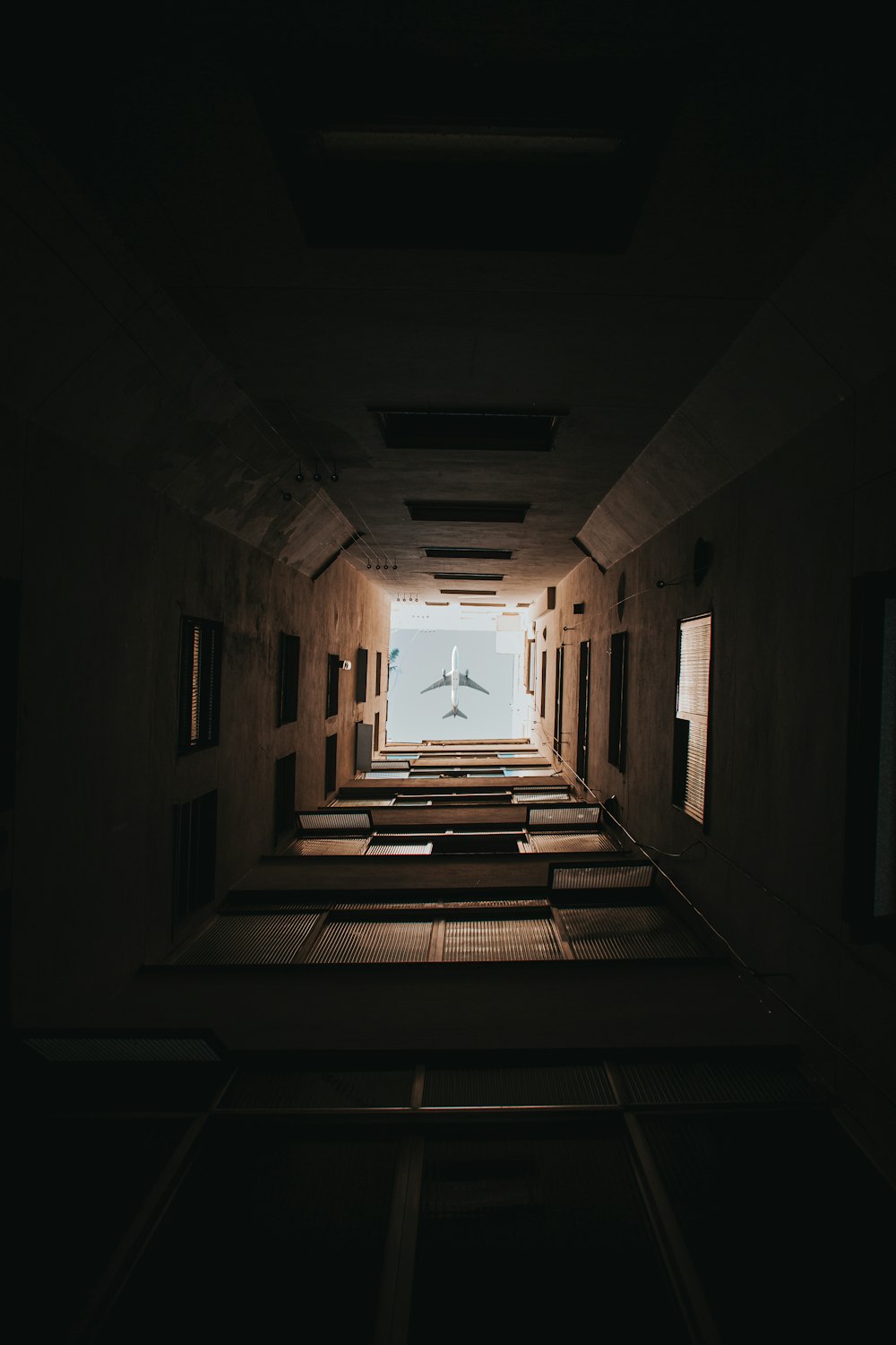 brown wooden hallway with white walls