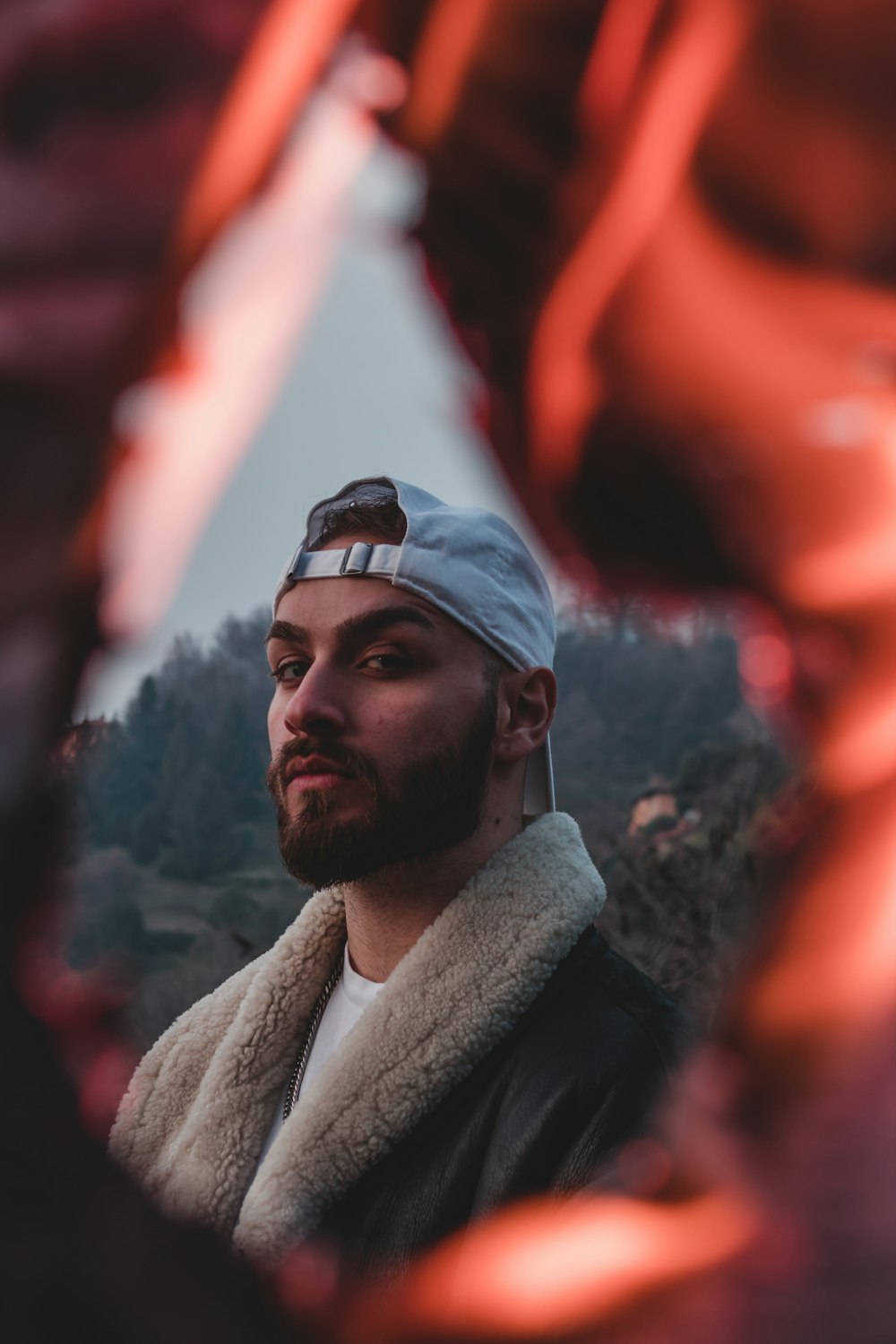 man in black jacket and white knit cap