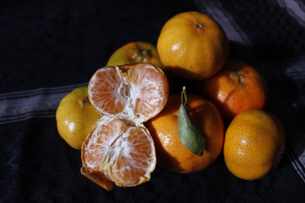 orange fruits on black textile