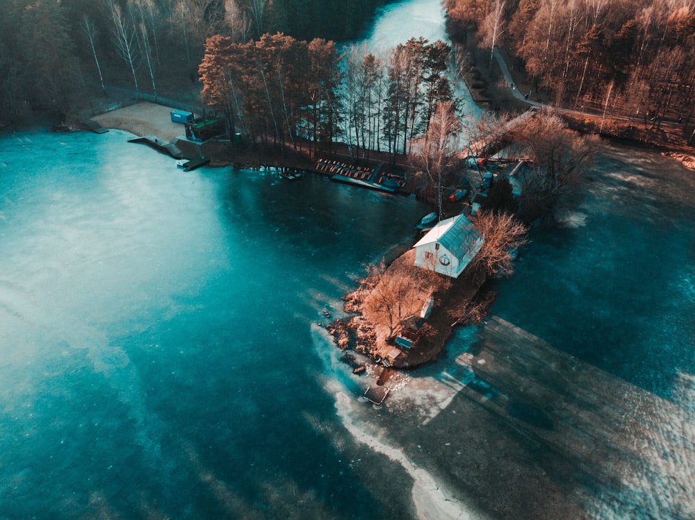 brown and white house beside river