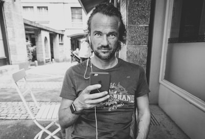 An engaging photo of a person using a smart gadget outdoors.