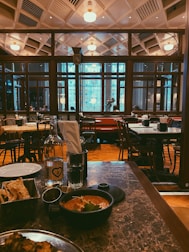 A cozy Turkish restaurant interior with cağ kebap dishes on the table.