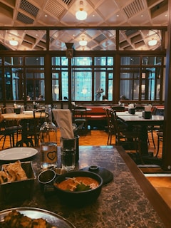 A cozy restaurant interior featuring warm-toned marble-finish wall sheets.