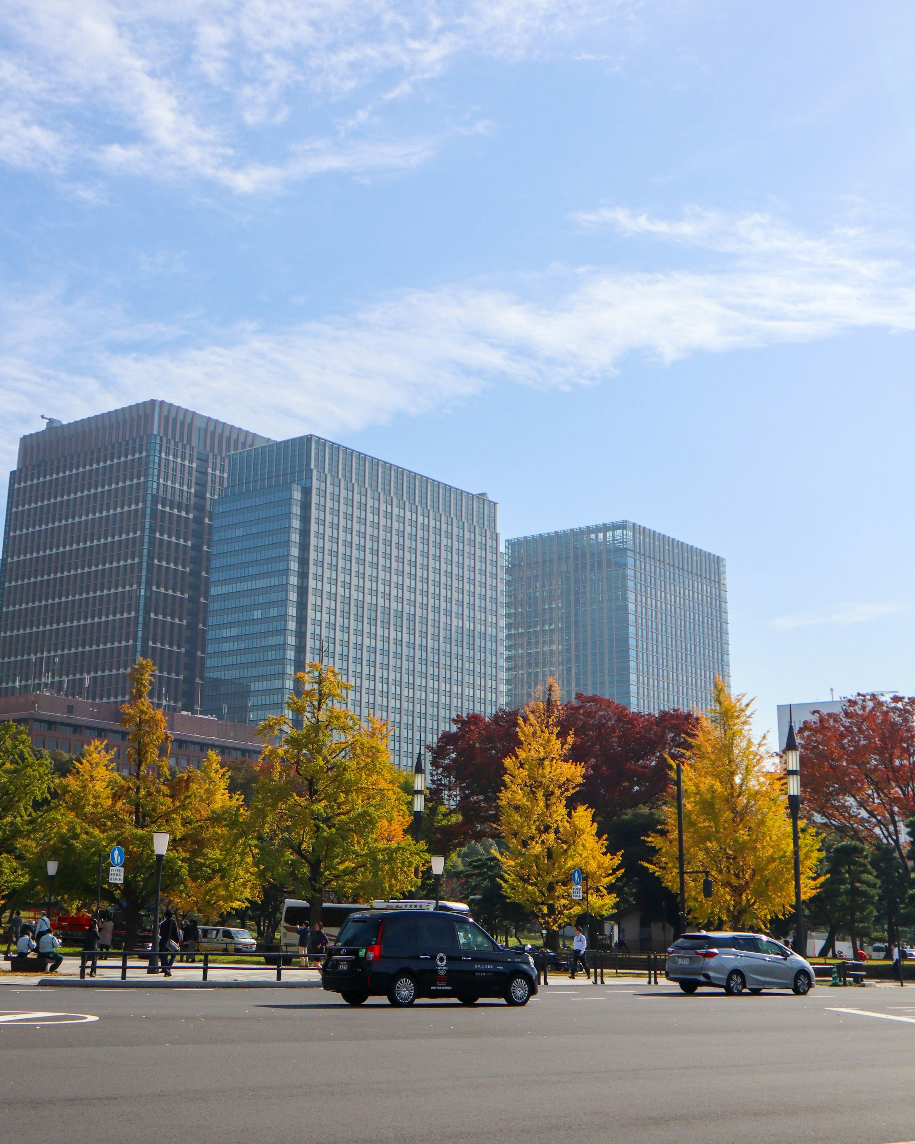 cars parked near high rise building during daytime