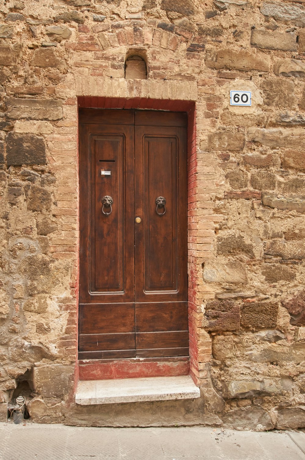 brown wooden door on gray concrete wall