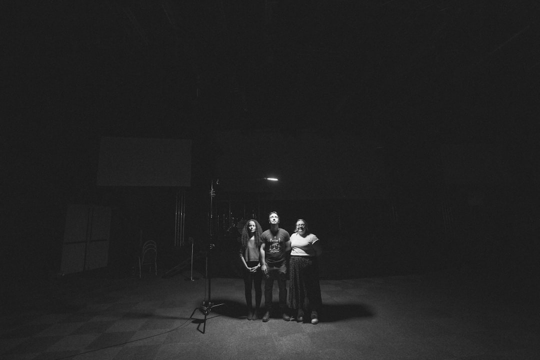 grayscale photo of people standing on stage
