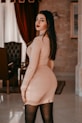 woman in white brassiere and panty standing near red curtain