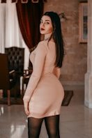 woman in white brassiere and panty standing near red curtain