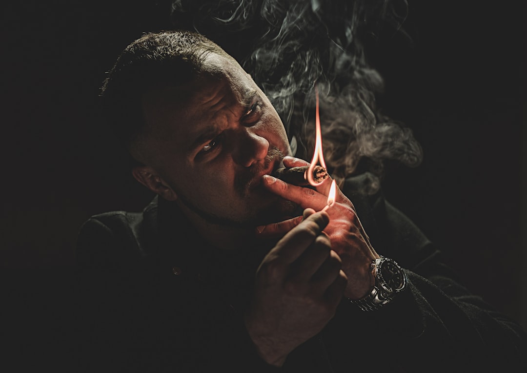 man in black shirt smoking cigarette