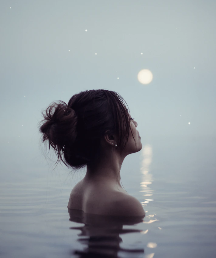 topless woman on water during daytime