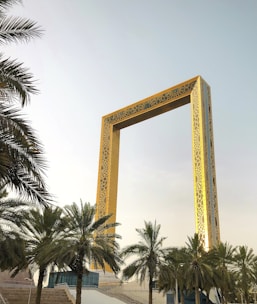 brown wooden cross with palm tree